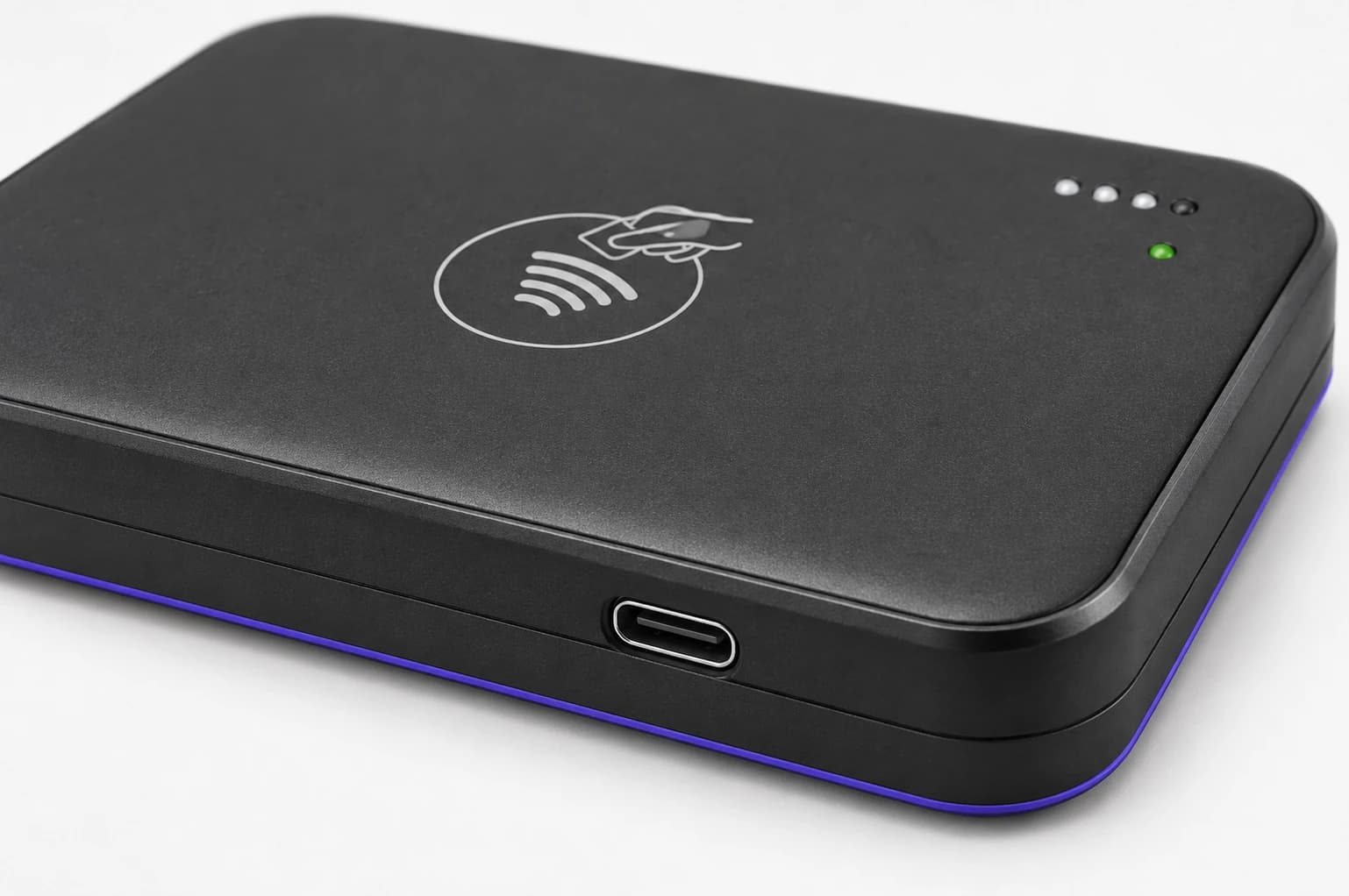 A close-up of a USB-C port on the side of the Trilogy card reader above its purple base.