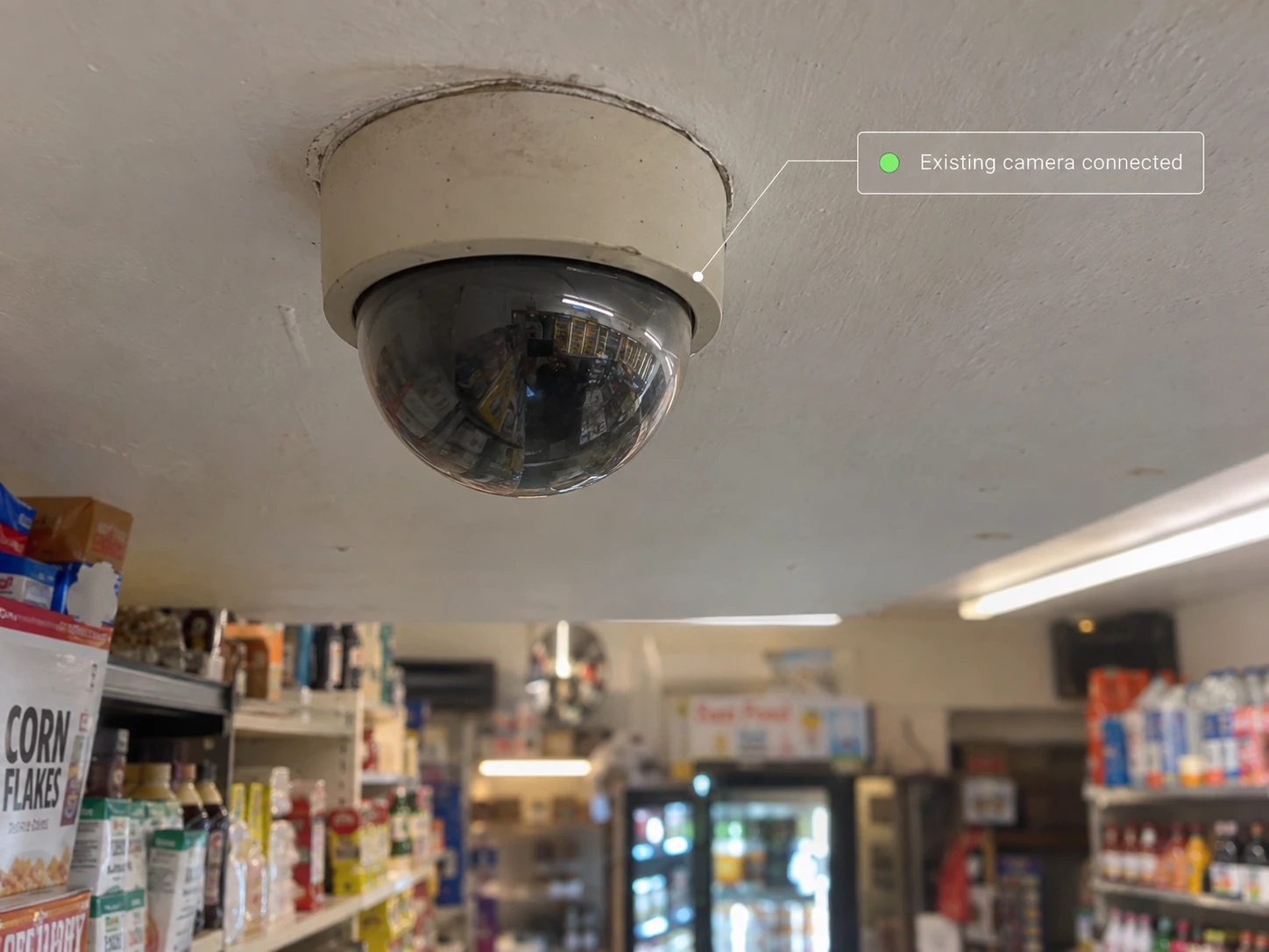 An existing ceiling camera in a neighborhood store with connected status