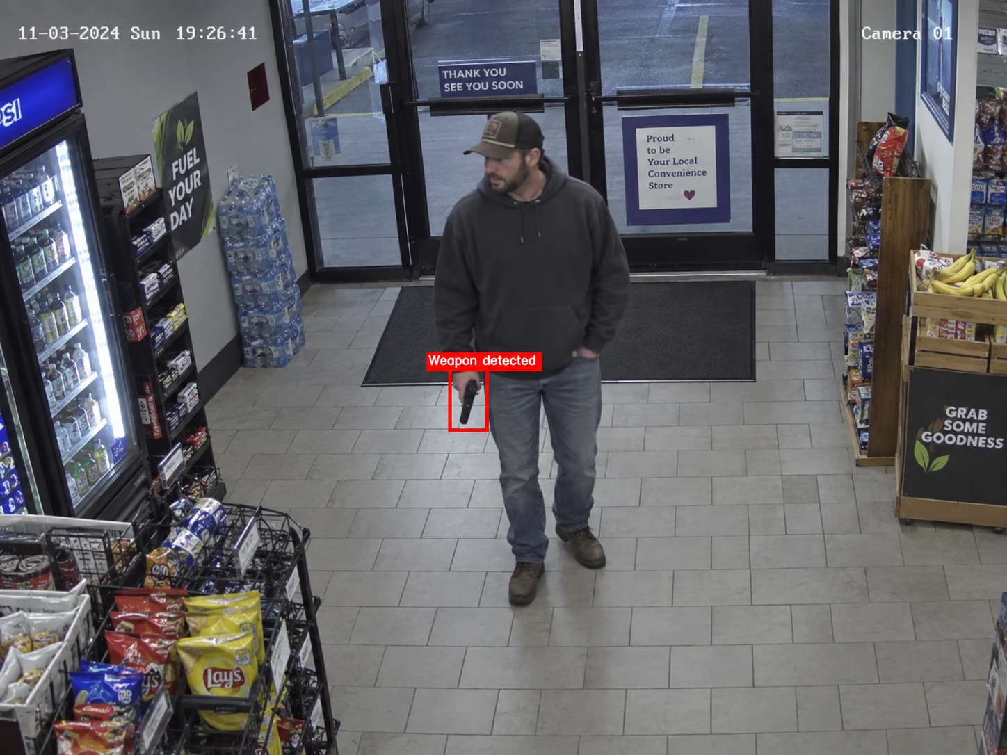A handgun highlighted by a weapon detection alert at a store entrance