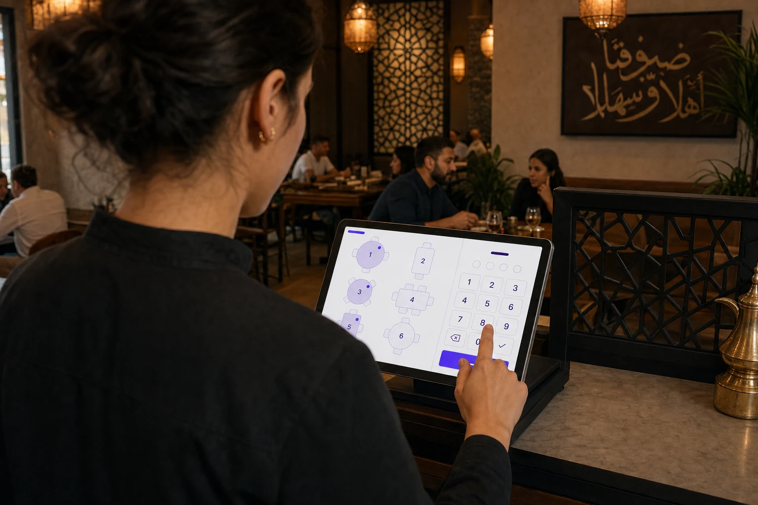 A restaurant host using a tablet to manage tables during service.