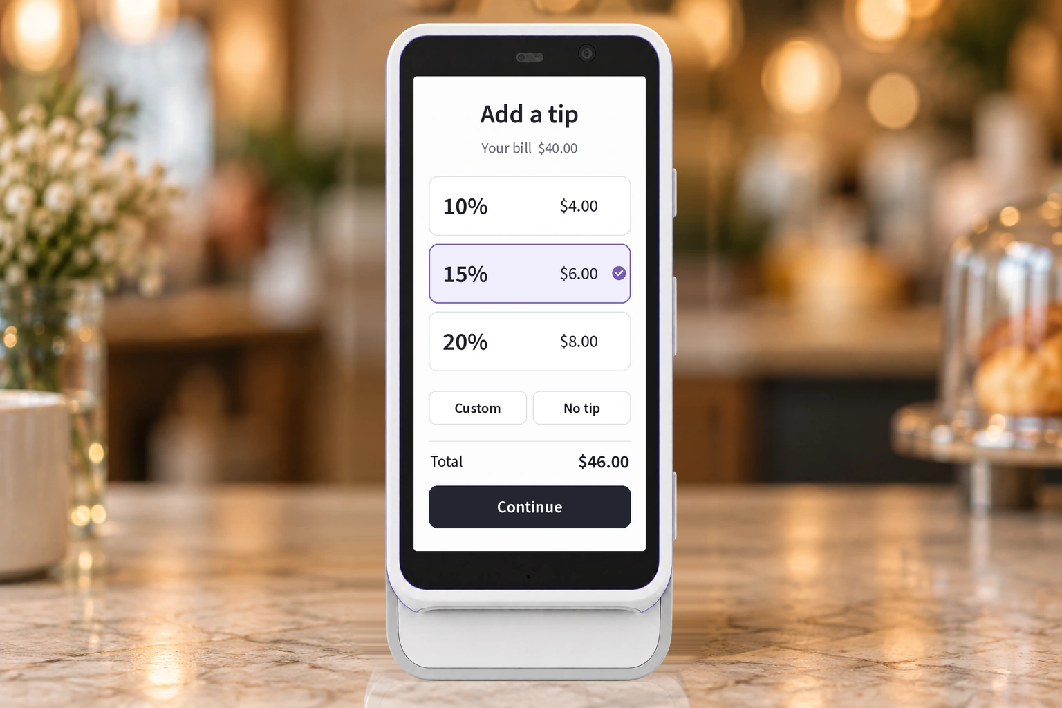 Front-facing Trilogy terminal showing 10%, 15%, and 20% tip choices against a heavily blurred cafe background.